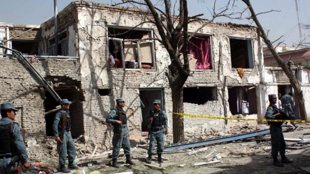 epa03716000 Afghan police inspect the scene of a gunbattle with Taliban militants who targeted a UN compound, in Kabul, Afghanistan, 25 May 2013. A Taliban assault on a United Nations building in Kabul ended after a fierce 10-hour gunbattle in which at least eight people were killed, officials said on 25 May. Two Afghan civilians, an Afghan police officer and five Taliban insurgents were among the dead. Four Nepalese guards, four foreigners, two police and two civilians were wounded. EPA/S. SABAWOON