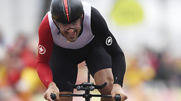 Zweite Goldmedaille für den 35-jährigen Schweizer Ein Radfahrer im rot-weissen Trikot rast auf einem Zeitfahrrad.