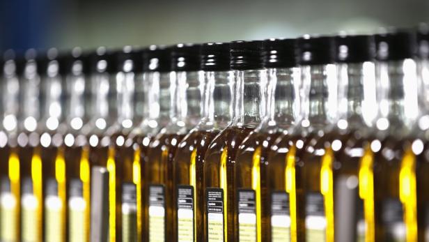 Bottles of olive oil are lined in a factory in Dos Hermanas, near the Andalusian capital of Seville September 21, 2012. Analysts and producers say the harvest in the world&#039;s largest olive oil producing country could well be half or less of what it was last year thanks to a harsh winter and drought that has shrivelled production, that has caused prices to spike, with consumers expected to pay more for the &#039;green gold&#039; in coming months as supermarkets jack up prices. Picture taken September 21, 2012. REUTERS/Marcelo del Pozo (SPAIN - Tags: ENVIRONMENT BUSINESS SOCIETY FOOD)