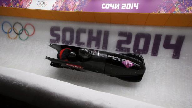 Ein Bob rast die Eisbahn in Sotschi 2014 hinunter.