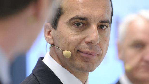 Ein Mann mit Mikrofon am Ohr lächelt in die Kamera.