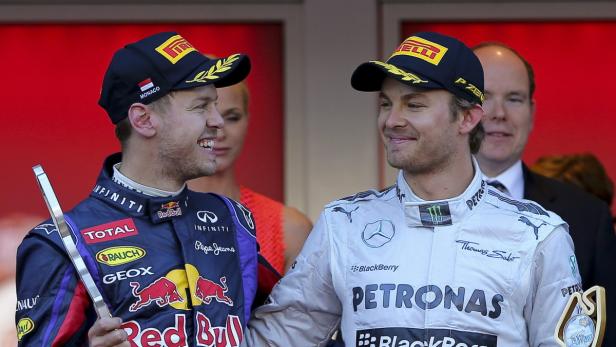 epa03718756 German Formula One driver Nico Rosberg (R) of Mercedes AMG celebrates with second placed compatriot Sebastian Vettel (L) of Red Bull Racing after winning the 2013 Formula One Grand Prix of Monaco at the Monte Carlo circuit in Monaco, 26 May 2013. EPA/VALDRIN XHEMAJ