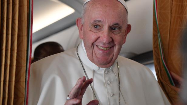 Pope Francis speaks to the media on board an Alitalia aircraft