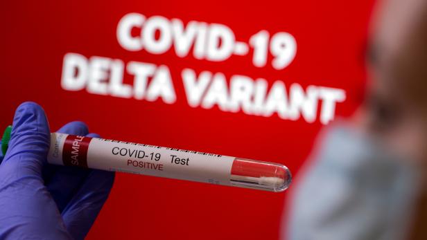 FILE PHOTO: FILE PHOTO: Illustration of a test tube labelled 'COVID-19 Test Positive' in front of displayed words 'COVID-19 Delta variant'