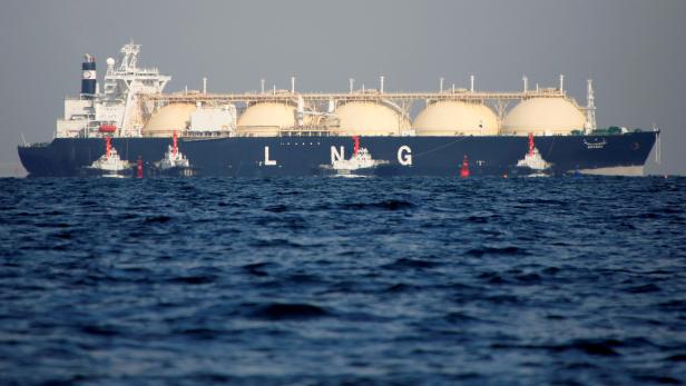 FILE PHOTO: An LNG tanker is tugged towards a thermal power station in Futtsu