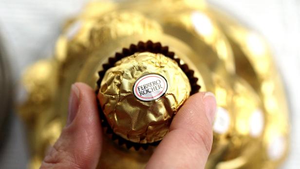 FILE PHOTO: A woman takes a Ferrero Rocher chocolate in Milan
