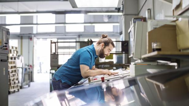 Designer working at printing factory Designer working at printing factory