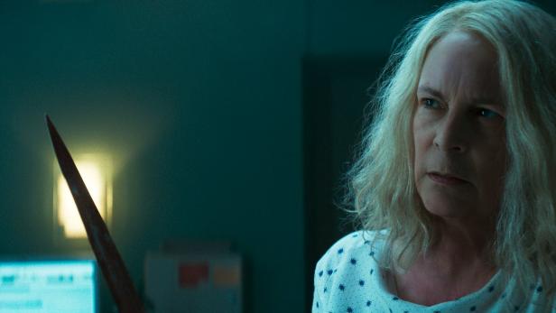 Vertraute Pose: Jamie Lee Curtis als Laurie Strode mit Messer und entschlossener Miene im Kinofilm „Halloween kills“, der im Kino zu sehen ist