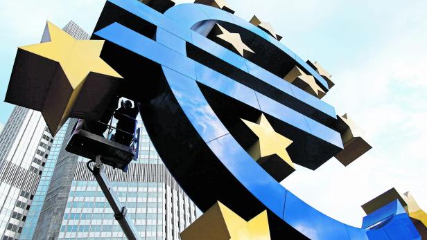 FILE PHOTO: Workers maintain the huge Euro logo in front headquarters of ECB in Frankfurt