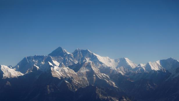 FILE PHOTO: Mount Everest, the world highest peak, and other peaks of the Himalayan range are seen through an aircraft window during a mountain flight from Kathmandu