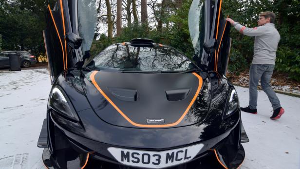 FILE PHOTO: Glynn displays his most recently acquired McLaren at his home in Headley Down