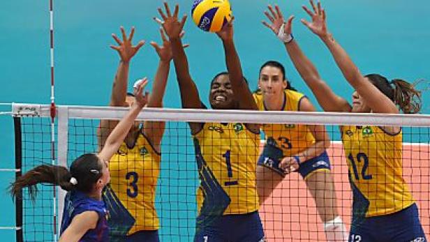 Volleyballspielerinnen kämpfen am Netz um den Ball.