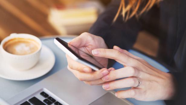 close up of hands using mobile application on smartphone