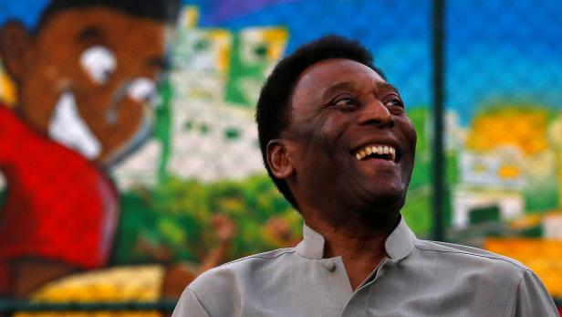 FILE PHOTO: Brazilian soccer legend Pele laughs during the inauguration of a refurbished soccer field at the Mineira slum in Rio de Janeiro