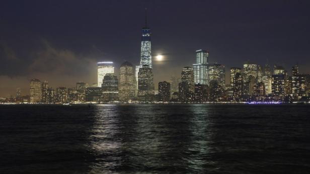 Die Skyline von New York City bei Nacht, beleuchtet vom Mond.