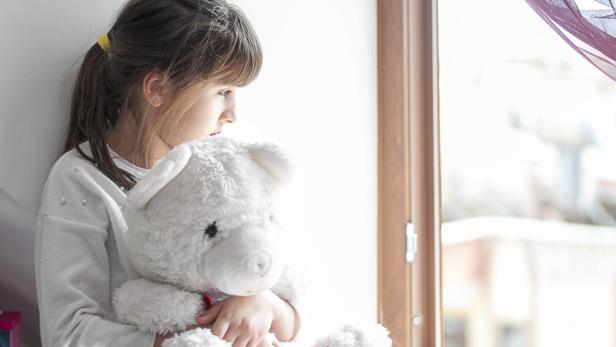 Cute girls boring at home with her teddy bear