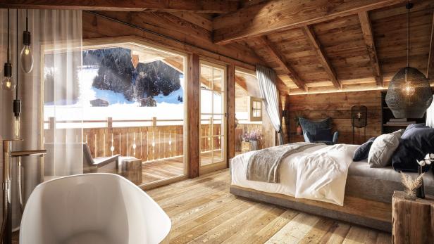 Ein Schlafzimmer im Chalet-Stil mit Holzbalken und Blick auf eine verschneite Landschaft.