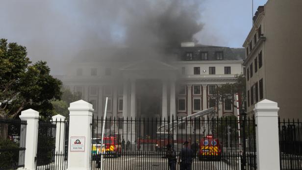 Firefighters work after a fire broke out in the Parliament in Cape Town