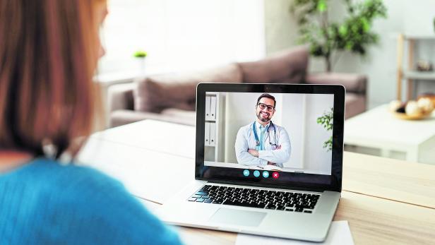 Woman making video call to doctor