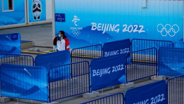 A staff member of the Beijing Olympic Organising Committee attends the rehearsal of a medal ceremony at the Medals Plaza of the Beijing 2022 Winter Olympics in Beijing