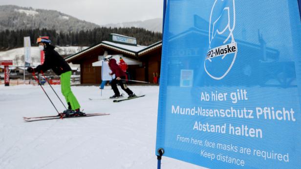 FILE PHOTO: Skiers wear protective face masks in Flachau