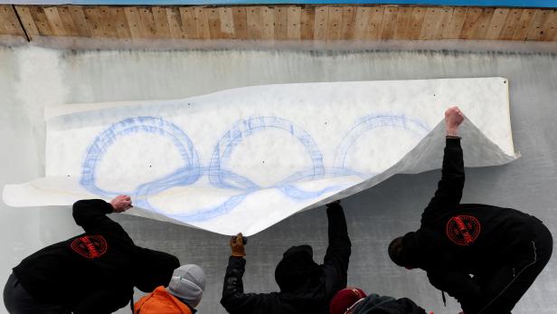 Ice makers install a sub-glacial Olympic logo ahead of the Beijing 2022 Winter Olympics at Yanqing National Sliding Center in Yanqing