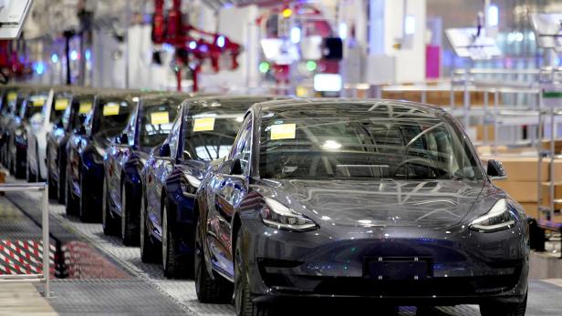 FILE PHOTO: Tesla's China-made Model 3 vehicles are seen during a delivery event at its factory in Shanghai