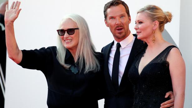 FILE PHOTO: The 78th Venice Film Festival - Screening of the film 'The Power of the Dog' in competition - Director Jane Campion, actor Benedict Cumberbatch and actor Kirsten Dunst pose