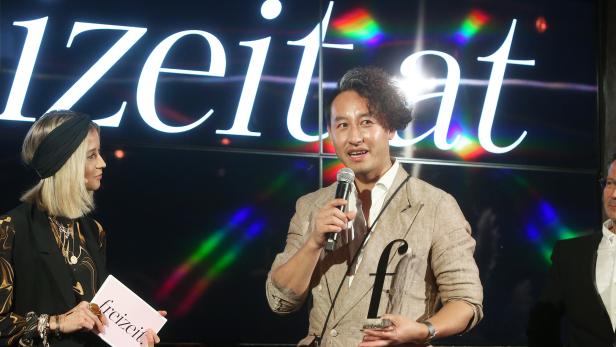 Ein Mann hält eine Auszeichnung der „Freizeit“ in der Hand und spricht ins Mikrofon.