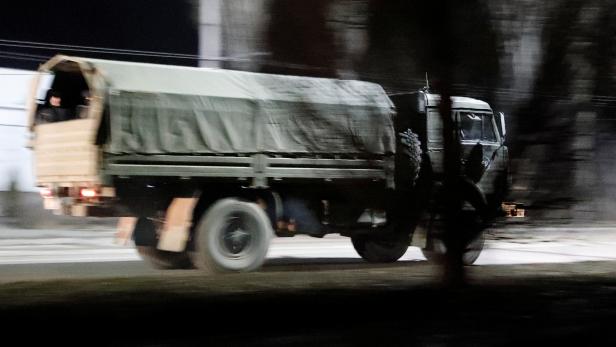 A military truck drives along a street in Donetsk