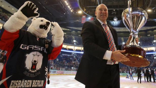 Coach Don Jackson of Eisbaeren Berlin celebrates winning the German Ice Hockey League (DEL) trophy after victory against Koelner Haie in the fourth game of the best-of-five final series at the O2 Arena in Berlin April 21, 2013. REUTERS/Tobias Schwarz (GERMANY - Tags: SPORT ICE HOCKEY)