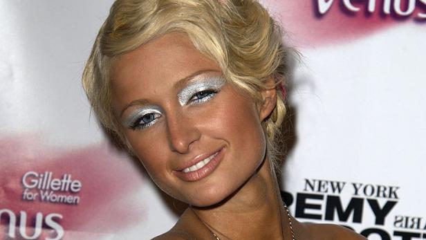 Paris Hilton mit silbernem Lidschatten und pinkfarbenem Kleid auf einer Veranstaltung.