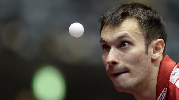 Ein Tischtennisspieler fixiert den Ball in der Luft.