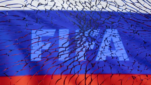Illustration shows FIFA logo and Russian flag through broken glass