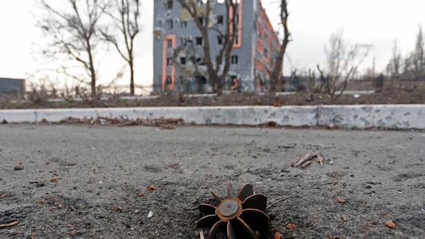 A part of a shell is seen in the street in the besieged city of Mariupol