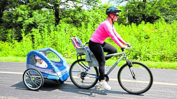 Woman on bike with trailer
