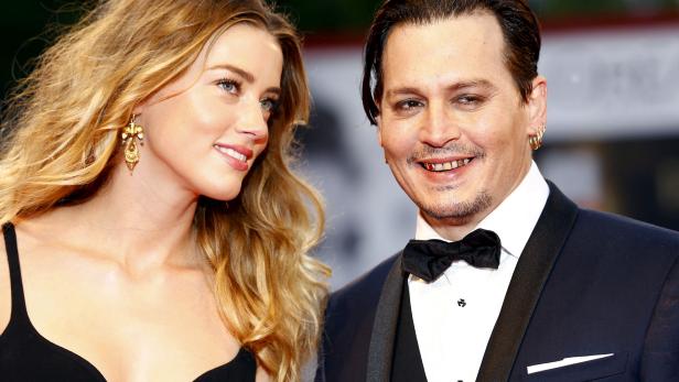 FILE PHOTO: Actor Johnny Depp and his wife Amber Heard attend the red carpet event for the movie "Black Mass" at the 72nd Venice Film Festival