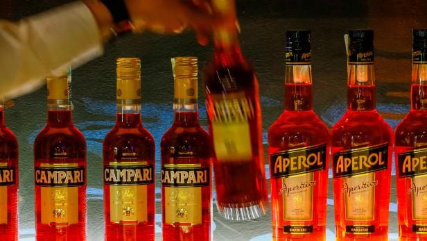 FILE PHOTO: A bartender takes a bottle of Campari at Barmaglot bar in Almaty
