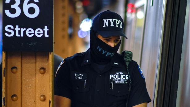 A New York Police Officer of the anti terrorism unit patrols the 36th St. subway station, a day after a shooting incident took place in the Brooklyn borough of New York
