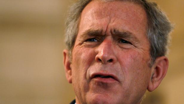 FILE PHOTO: President  Bush reacts to a question after a man threw a shoe at him in Iraq