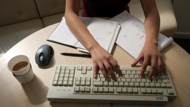 FILE PHOTO: A woman works at her desk in this illustration picture