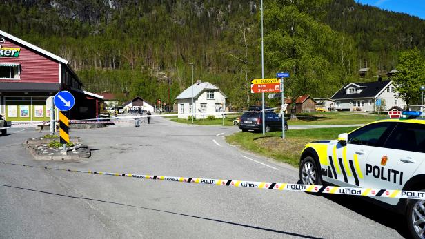 A police vehicle is parked on the side of the road following stabbing attacks, in Nore, Numedal region