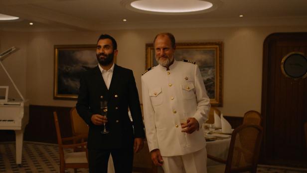 Willkommen an Bord: Woody Harrelson (re.) als ewig besoffener Kapitän eines untergehenden Schiffs in Ruben Östlunds Groteske „Triangle of Sadness“ in Cannes