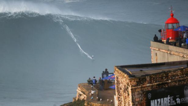German surfer Sebastian Steudtner drops in on a large wave during Nazare Tow Challenge at Praia do Norte in Nazare
