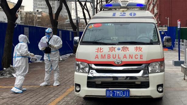 Ambulance staff prepare to transfer a media worker who tested positive for COVID-19 during the Beijing 2022 Winter Olympics in Beijing