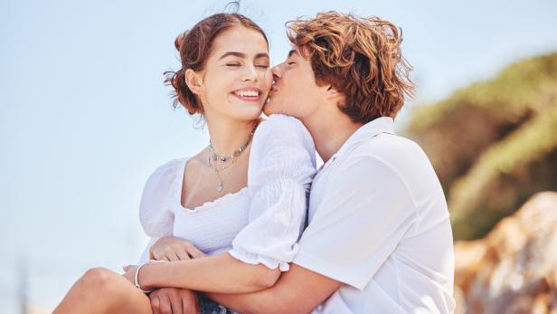 Shot of a young couple spending time together at the beach