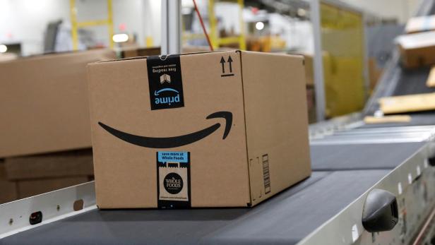 FILE PHOTO: Packaged merchandise is seen on a conveyer belt at the Amazon fulfillment center in Robbinsville