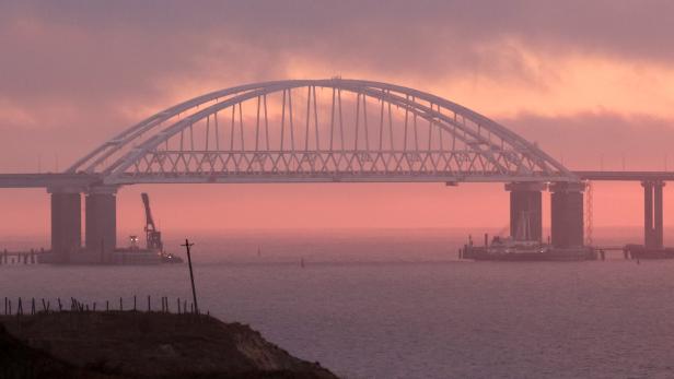 FILE PHOTO: A general view shows a road-and-rail bridge, constructed to connect the Russian mainland with the Crimean peninsula, at sunrise in the Kerch Strait, Crimea