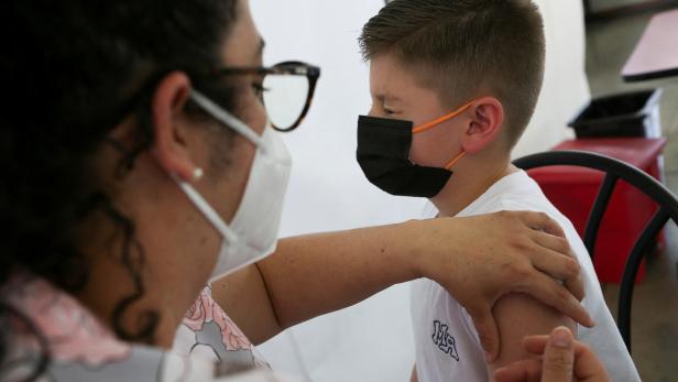 FILE PHOTO: Children age 5 and up receive vaccinations against the coronavirus disease (COVID-19), in San Jose