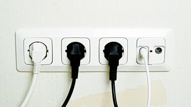 Plugs connected to the outlet in a wall